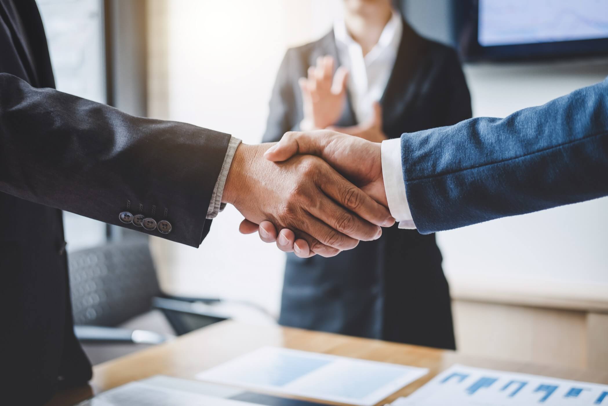 finishing-up-a-meeting-business-shaking-hands-after-discussing-good-deal-of-trading-to-sign-agreement_t20_ZV0Lnb.jpg