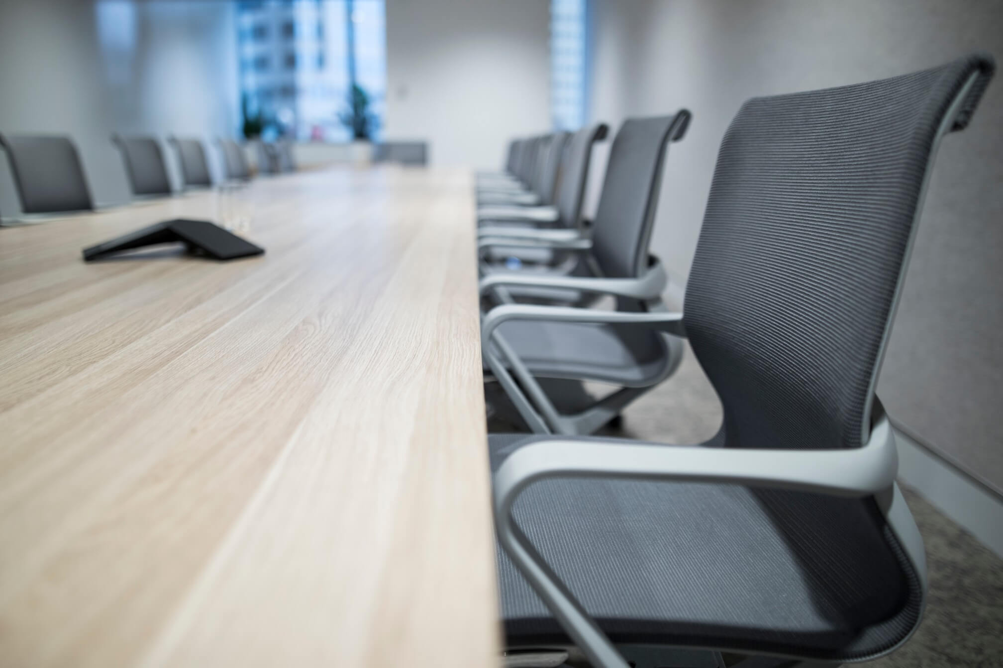 view-of-a-long-board-room-table-with-chairs-against-the-window-which-has-a-view-of-the-sydney-office_t20_kob6Ep.jpg